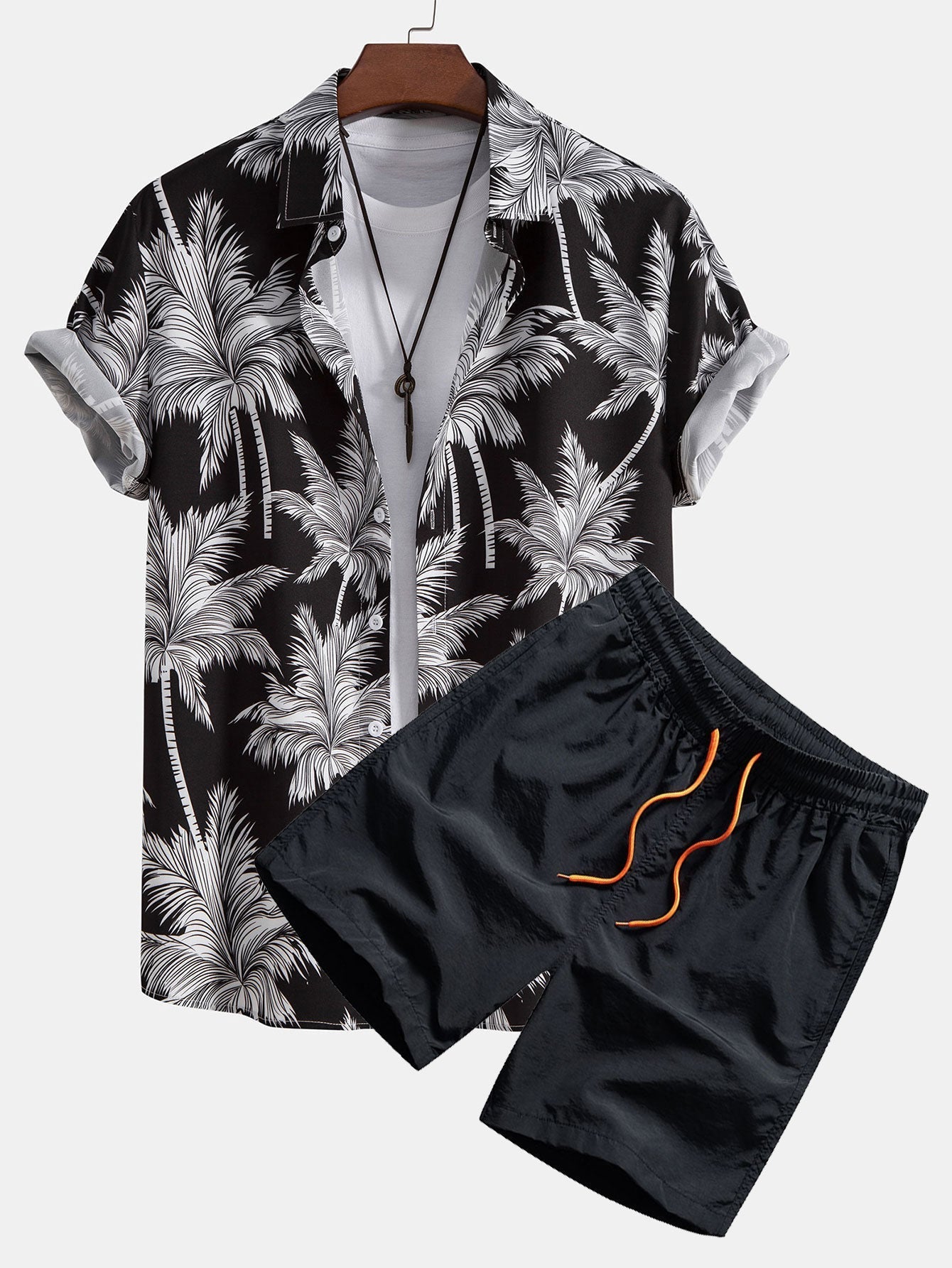 Skjorte med knapp og badeshorts med palmetreprint